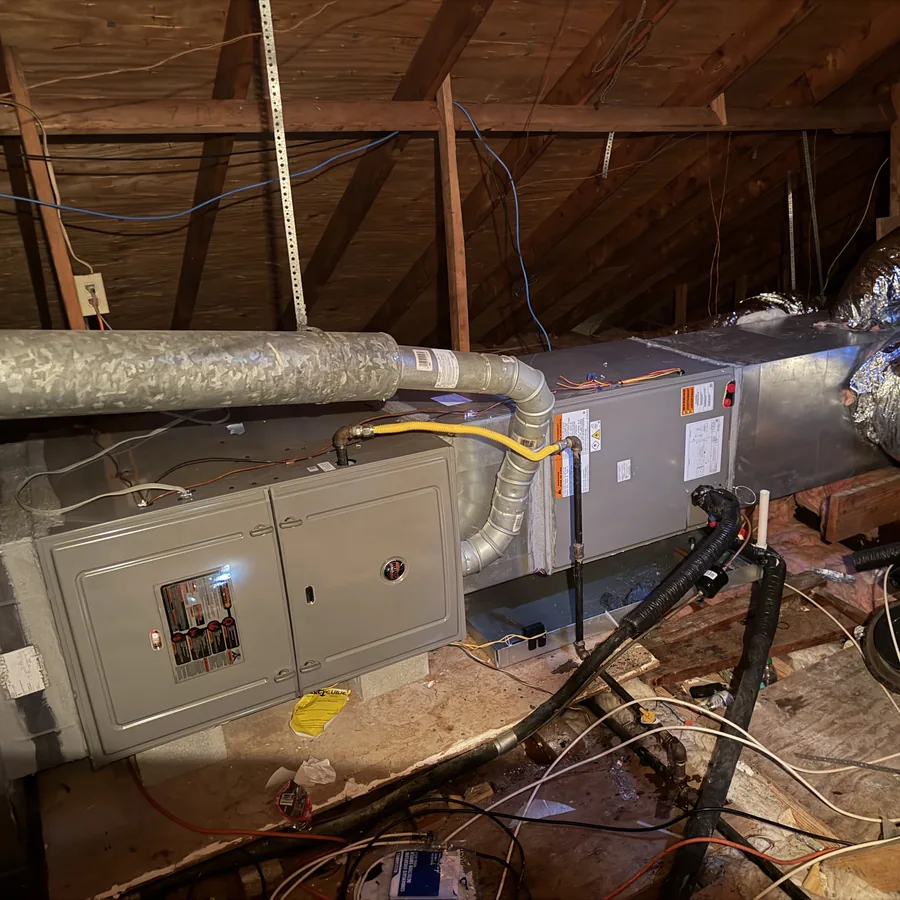 Attic air handler and electrical service panel during a service visit