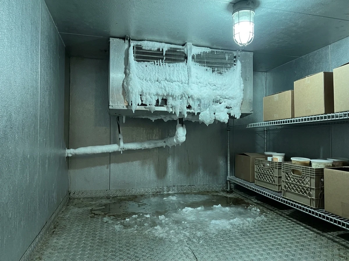 Walk-in cooler evaporator iced over solid before repair